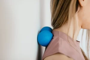 Woman using self myofascial balls on her neck