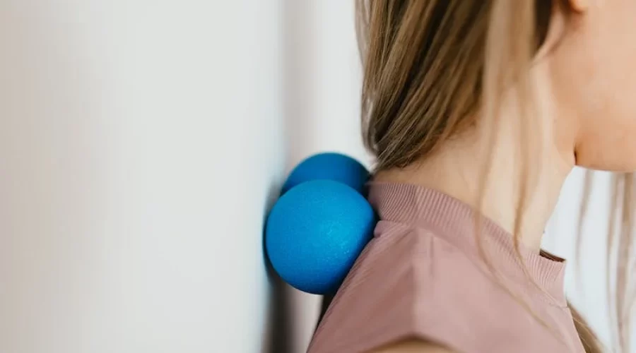 Woman using self myofascial balls on her neck